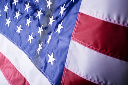 A closeup shot of the waving flag of the United States of America with interesting textures