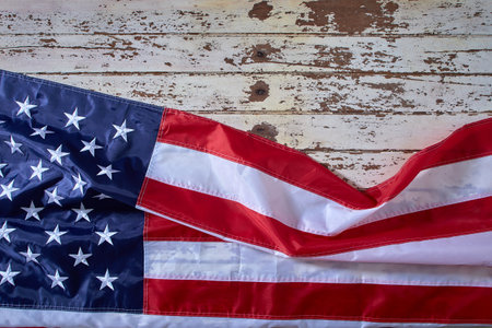 American Flag for America's 4th of July Celebration over a white wooden rustic background to mark America's Independence Day. Image shot from the top viewの写真素材