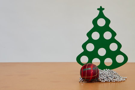 Christmas trees and Christmas ball on a wooden table white backgroundの写真素材