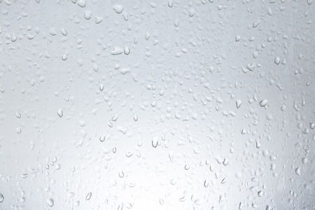 Water droplets on the vertical glass.の写真素材