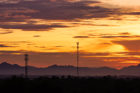 Cellular and telecommunication tower in the hill on the background of red sunset.の写真素材