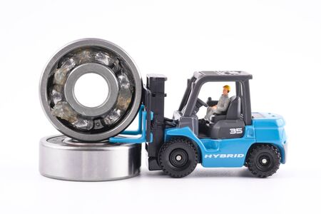 Miniature People : Engineer driving forklift and lift up ball bearing which have Lithium grease...