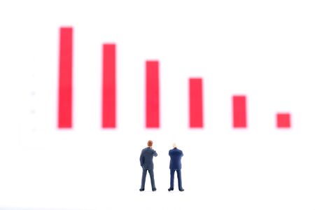 Miniature people:Businessman standing with team and discuss on the stock trend with copy space. Financial crisis. Data analysis. Stock market volatility risk. Information for investment.の写真素材
