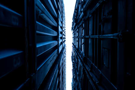 Logistic and transportation container cargo ship in the container yard shipping area. Industrial for logistic import and export business. Harbor freight blue tone. stacking of containers.の写真素材