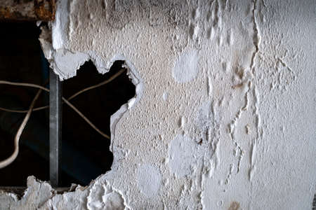 A huge hole of ceiling panels was damages from rainwater leakage in the abandoned house. Ceiling floor swelling and have fungi. Collapsed roof from natural disaster. Maintenance and repair conceptの写真素材