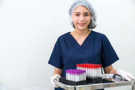 Woman doctor or specialist in uniform wearing white cap standing in the clinic with copy space....