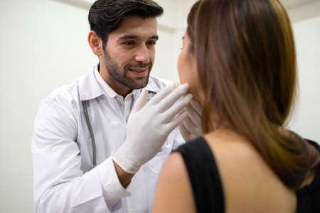 Beautiful woman check skin and face with doctor before plastic surgery in the clinic. Beautician...