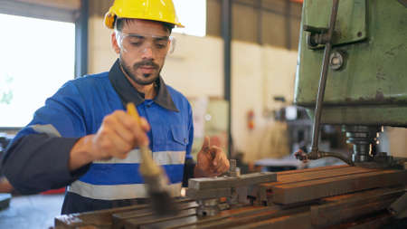 Engineer wearing safety helmet and glasses standing in the production of manufacturing factory....