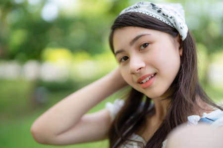 Pretty attractive woman standing in the garden with blur background. Girl doing selfie on sunny day. Happiness during vacation. Relaxation, Aromatherapy freedom feeling lifestyleの写真素材