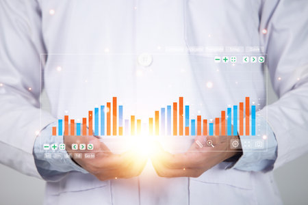 Financial charts showing growing revenue on touch screenの写真素材