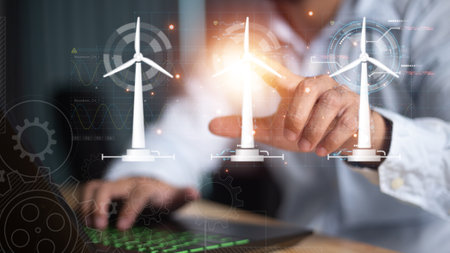 Close up of businessman hand pointing at cellphone with glowing digital wind mill turbine hologram. Wind generator concept.の写真素材