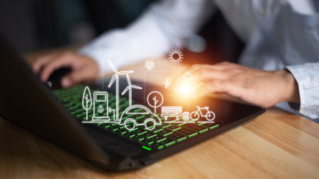 Man using a smart home control system on a laptop with application that controls home electronics in a black background. Smart home conceptの写真素材
