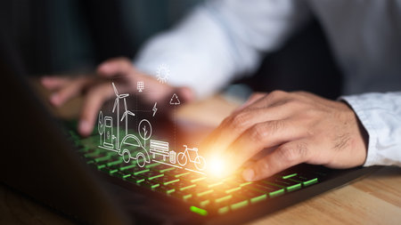 Energy and Power icons with businessman working on laptop computer at office deskの写真素材