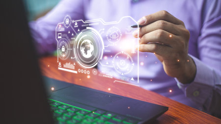 Businessman pointing at hologram with icon on virtual screen, Smart factory technology interfaceの写真素材