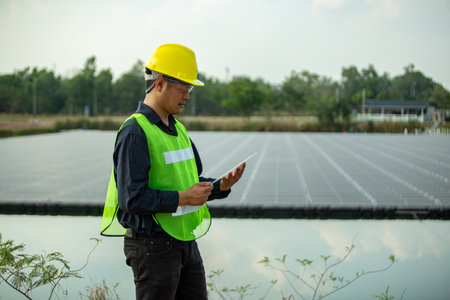 Engineer using tablet computer at solar power plant. Engineer using tablet computer at solar power plant.の写真素材
