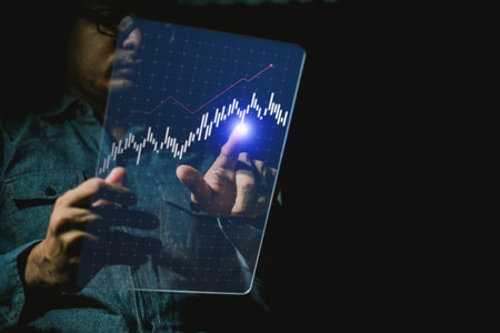 Businessman analyzing investment charts with tablet computer. Business and financial concept.の写真素材