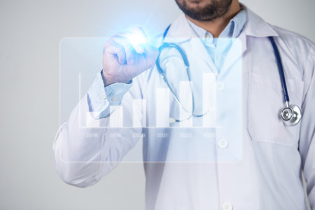 Close-up of male doctor touching virtual screen with stethoscopeの写真素材