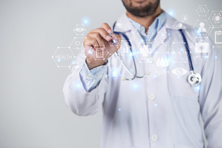 Close up of male doctor writing on virtual screen with stethoscopeの写真素材
