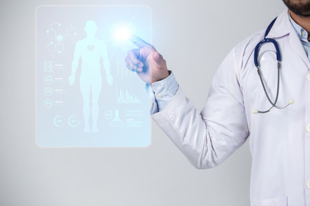 Close up of male doctor touching hologram screen with stethoscopeの写真素材