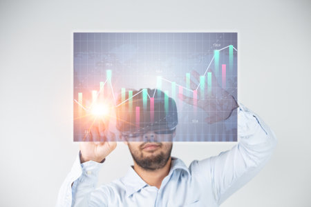 businessman wearing virtual reality goggles with stock market chart on screen over gray background