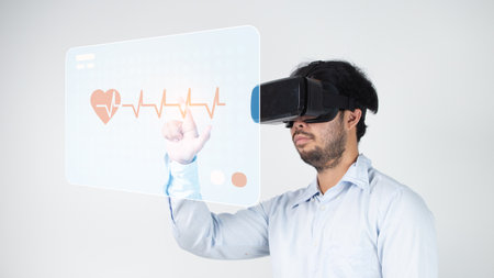 Businessman using  VR glasses with cardiogram on white backgroundの写真素材