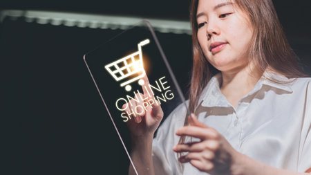 Young asian woman using tablet with shopping cart icon. Online shopping concept.の写真素材