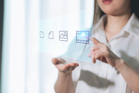 Woman holding a tablet with the image of a file on the screenの写真素材
