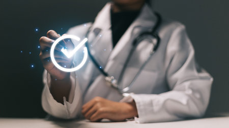 Close up of female doctor with stethoscope working on virtual screenの写真素材