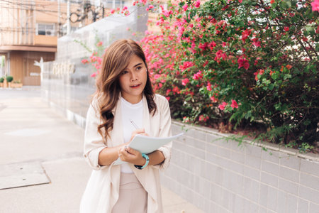 young asian businesswoman writing in notebookの写真素材