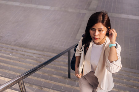 young beautiful hipster woman listening music with earphones in the cityの写真素材