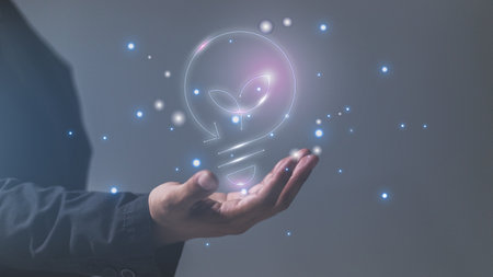 Businessman holding a glowing lightbulb in his hand 3D renderingの写真素材