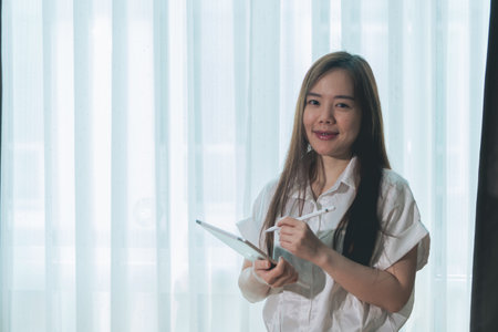 Portrait of young businesswoman using digital tablet in the office.の写真素材