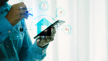 Businessman using smart phone and digital tablet with smart home automation systemの写真素材