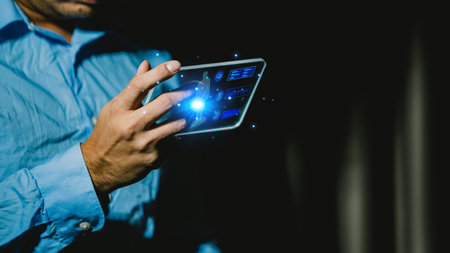 Businessman using tablet computer in dark room. Business and technology concept.の写真素材