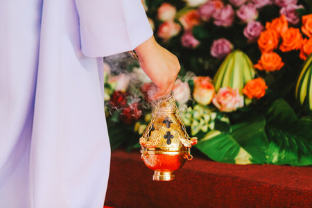Hands of the bride and groom with a burning incense in the templeの写真素材