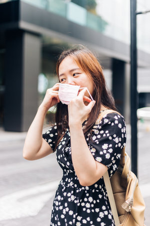 Asian woman wearing face mask to protect from Influenza virusの写真素材