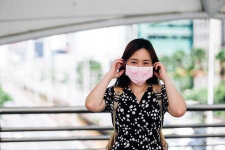 Asian woman wearing face mask to protect from Influenza virusの写真素材