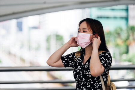 Asian woman wearing face mask to protect from Influenza virusの写真素材
