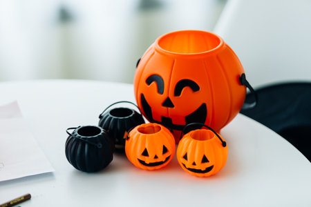 Halloween pumpkins with candies on white table, closeupの写真素材