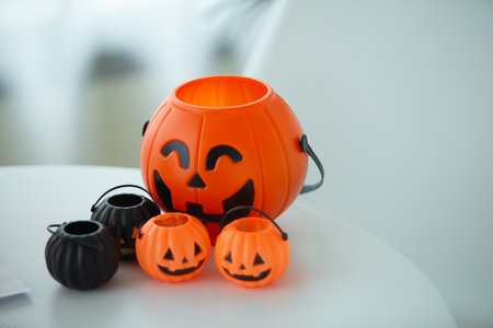 Halloween pumpkins with candies on white table, closeupの写真素材