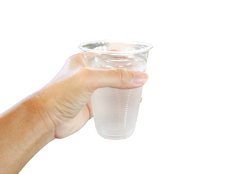 A hand holding a plastic cup of water isolated on white backgroundの写真素材