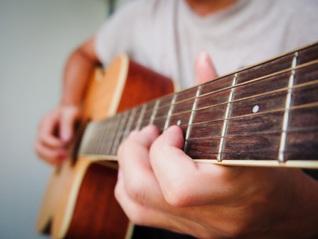 Closeup an acoustic guitar being playedの写真素材