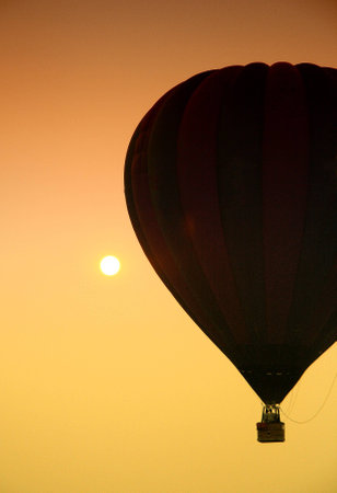 Hot air balloon with setting sunの写真素材