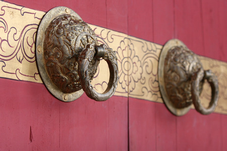 Brass knocker on wooden doorsの写真素材