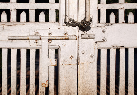 A gate locked with a yale and chain