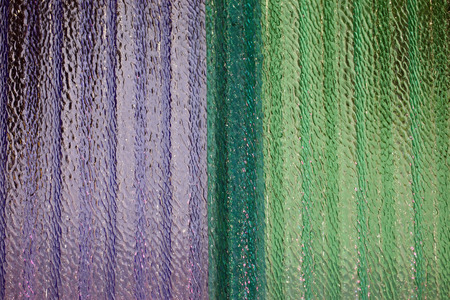 corrugated and translucent glass of window - Purple and green coloredの写真素材