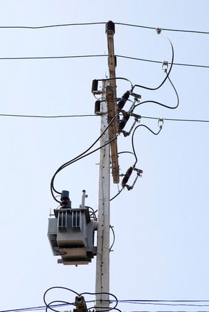 Distribution transformert on the concrete pole and wires.
