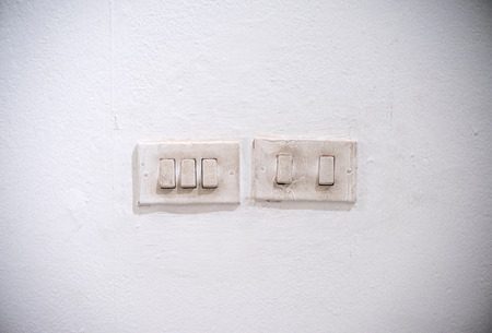old light switch on the white wallの写真素材