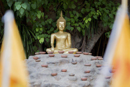 the Buddha with candles and in Phan Tao Temple, Chiangmai, Thailandの写真素材