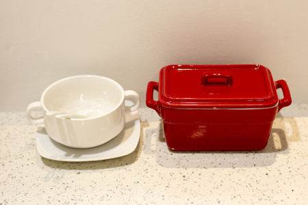 A white cup and red box on marble tableの写真素材